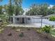 Charming single-story home with a gray exterior and a covered parking area in front at 1414 Beaver Pl, Orlando, FL 32806