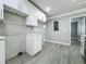 Bright kitchen with stainless steel appliances, updated countertops, and gray tile backsplash at 1414 Beaver Pl, Orlando, FL 32806