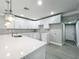 Beautiful kitchen with white cabinets, stainless steel appliances, and wood-look tile flooring at 1414 Beaver Pl, Orlando, FL 32806