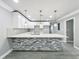 Bright kitchen boasts white cabinets, quartz countertops, and a stylish island with stone accents at 1414 Beaver Pl, Orlando, FL 32806