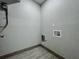 Utility room with tile floor and textured walls at 1414 Beaver Pl, Orlando, FL 32806