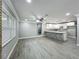 Open-concept living room showcases a brick accent wall, modern gray flooring, and a stylish kitchen counter at 1414 Beaver Pl, Orlando, FL 32806