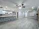 Expansive living area with brick fireplace, gray tile floors, opens to a kitchen with modern white cabinetry at 1414 Beaver Pl, Orlando, FL 32806