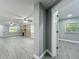View from hallway to the large living room featuring a brick fireplace and wood-look floors at 1414 Beaver Pl, Orlando, FL 32806