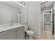 Updated bathroom with tile floors, gray vanity and a view of shower at 14820 Laguna Beach Cir, Orlando, FL 32824