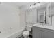 White bathroom with tub, shower, light gray vanity, and tile floors at 14820 Laguna Beach Cir, Orlando, FL 32824