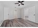 Bright bedroom featuring wood-look floors, a ceiling fan, closet and an attached bathroom at 14820 Laguna Beach Cir, Orlando, FL 32824