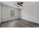 Bright bedroom with neutral paint, wood floors and a ceiling fan at 14820 Laguna Beach Cir, Orlando, FL 32824