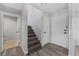 Bright foyer featuring wood-look floors, staircase, closet, and a modern front door at 14820 Laguna Beach Cir, Orlando, FL 32824