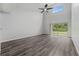 Bright and spacious living room with wood-look floors, ceiling fan and sliding glass doors at 14820 Laguna Beach Cir, Orlando, FL 32824
