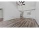 Bright and airy living room featuring wood-look floors, high ceilings, and modern ceiling fan at 14820 Laguna Beach Cir, Orlando, FL 32824