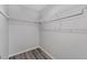 Spacious walk-in closet with ample storage on shelves and gray wood-look floors at 14820 Laguna Beach Cir, Orlando, FL 32824