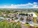 Beautiful aerial view of a lakeside community with well-maintained homes and verdant trees at 1513 Blue Sky Way, Clermont, FL 34714