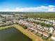 Stunning aerial view of a residential neighborhood with serene lakes and lush green spaces at 1513 Blue Sky Way, Clermont, FL 34714