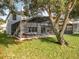 Spacious backyard featuring a screened-in pool and patio, perfect for outdoor living at 1513 Blue Sky Way, Clermont, FL 34714