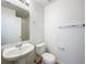 Powder room featuring a pedestal sink and modern fixtures at 1513 Blue Sky Way, Clermont, FL 34714