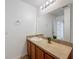 Bathroom with a framed mirror, vanity, and decorative plant at 1513 Blue Sky Way, Clermont, FL 34714