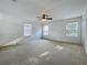 This bedroom features three windows allowing for tons of natural light and a ceiling fan at 1513 Blue Sky Way, Clermont, FL 34714