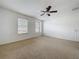Bedroom with a ceiling fan and two windows, providing lots of natural light at 1513 Blue Sky Way, Clermont, FL 34714