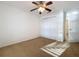 Neutral bedroom with a ceiling fan and double closet doors at 1513 Blue Sky Way, Clermont, FL 34714