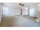 This bedroom offers carpeted floors, a ceiling fan, and a closet at 1513 Blue Sky Way, Clermont, FL 34714