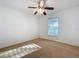 Neutral bedroom with a ceiling fan and a window at 1513 Blue Sky Way, Clermont, FL 34714