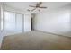This bedroom offers a neutral palette, carpet, and a ceiling fan with light at 1513 Blue Sky Way, Clermont, FL 34714