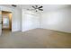 Carpeted bedroom features a ceiling fan and a double-door closet for storage at 1513 Blue Sky Way, Clermont, FL 34714