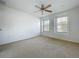 This bedroom features natural light from the two windows and a ceiling fan at 1513 Blue Sky Way, Clermont, FL 34714