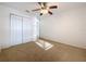 Spare bedroom featuring a ceiling fan, closet doors, and neutral paint at 1513 Blue Sky Way, Clermont, FL 34714