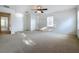 This bedroom offers carpeted floors, natural light and a ceiling fan at 1513 Blue Sky Way, Clermont, FL 34714