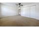 Carpeted bedroom with a ceiling fan and large closet, offering ample space at 1513 Blue Sky Way, Clermont, FL 34714