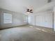 This bedroom features two windows, a ceiling fan, and ample closet space at 1513 Blue Sky Way, Clermont, FL 34714