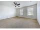 Bright bedroom with a ceiling fan and two windows for natural light at 1513 Blue Sky Way, Clermont, FL 34714