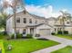 Charming two-story home with a well-manicured lawn and a spacious two-car garage at 1513 Blue Sky Way, Clermont, FL 34714