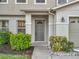Welcoming front entrance with a classic door, manicured bushes, and a well-lit entry at 1513 Blue Sky Way, Clermont, FL 34714