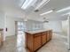 Open-concept kitchen flows into the living area, featuring an island and access to the backyard through sliding doors at 1513 Blue Sky Way, Clermont, FL 34714
