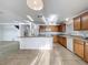 Spacious kitchen with an island, tile flooring, and plenty of natural light offers a functional layout at 1513 Blue Sky Way, Clermont, FL 34714