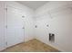 Functional laundry room with tile flooring and wire shelving for storage at 1513 Blue Sky Way, Clermont, FL 34714