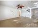 Bright living area with a ceiling fan, neutral paint, and access to other rooms of the house at 1513 Blue Sky Way, Clermont, FL 34714