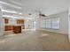 Open-concept living room and kitchen features neutral tones, natural light, and sliding door access to the outdoors at 1513 Blue Sky Way, Clermont, FL 34714
