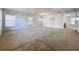Bright and airy living room with ample natural light and neutral carpeting throughout at 1513 Blue Sky Way, Clermont, FL 34714