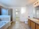 Ensuite bathroom with a soaking tub and walk-in shower at 1513 Blue Sky Way, Clermont, FL 34714