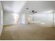 Large carpeted main bedroom with an ensuite bathroom at 1513 Blue Sky Way, Clermont, FL 34714