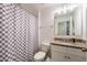 Cozy bathroom featuring a checkered shower curtain, granite countertop, and a white vanity at 16162 Arbor Crest Aly, Winter Garden, FL 34787