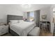 Bedroom with a gray upholstered headboard, a window with blinds, and a gray desk with a chair at 16162 Arbor Crest Aly, Winter Garden, FL 34787