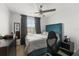 Comfortable bedroom with a plush teal headboard, ceiling fan, and lots of natural light from the window at 16162 Arbor Crest Aly, Winter Garden, FL 34787