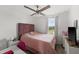 Bedroom features a pink bed, ceiling fan, window with curtains, and a desk at 16162 Arbor Crest Aly, Winter Garden, FL 34787
