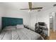 Bright bedroom with a modern ceiling fan, light-colored wooden floors, and an ample study space at 16162 Arbor Crest Aly, Winter Garden, FL 34787