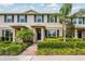 Charming townhouse featuring a well-maintained lawn, blue shutters, and a brick walkway at 16162 Arbor Crest Aly, Winter Garden, FL 34787